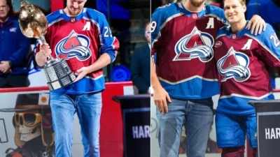 Nikola Jokic presents the Hart Trophy to Nathan MacKinnon before of the Avalanche’s home opener