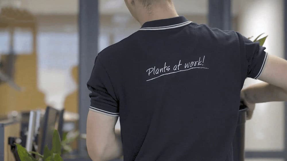 Frenchams Group worker with a plants at work tee-shirt