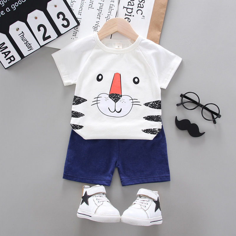 A stylish summer suit for boys giving your child a sophisticated look, consisting of two pieces of shorts and a t-shirt featuring a tiger print