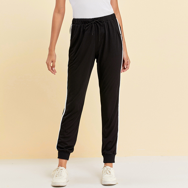 Excellent sports pants for women, black, with a distinctive thin white line, comfortable and flexible in clothing, with high quality