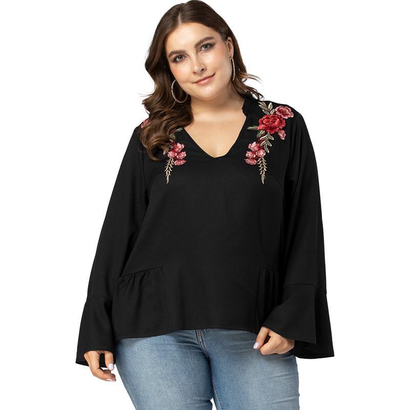 A loose-fitting autumn and winter women's T-shirt with a V-neck in a large size and beautiful flowers on its condensed high quality and distinctive