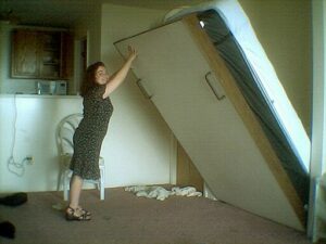 A woman opening a Murphy bed