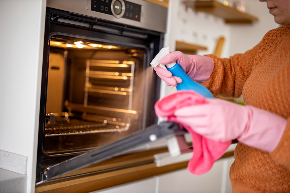 A Woman Using a DIY Oven Cleaner