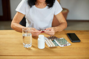 A senior woman taking medications and supplements that lead to balding