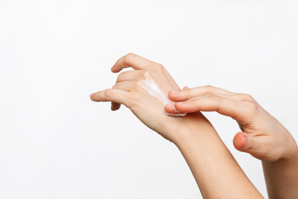 A closeup shoot of a woman's hand using Lubriderm Lotion