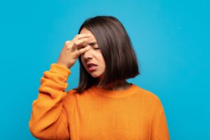 A woman experiencing headache due to antifungal treatment