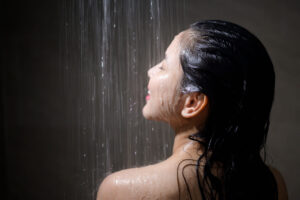 A woman taking a cool shower