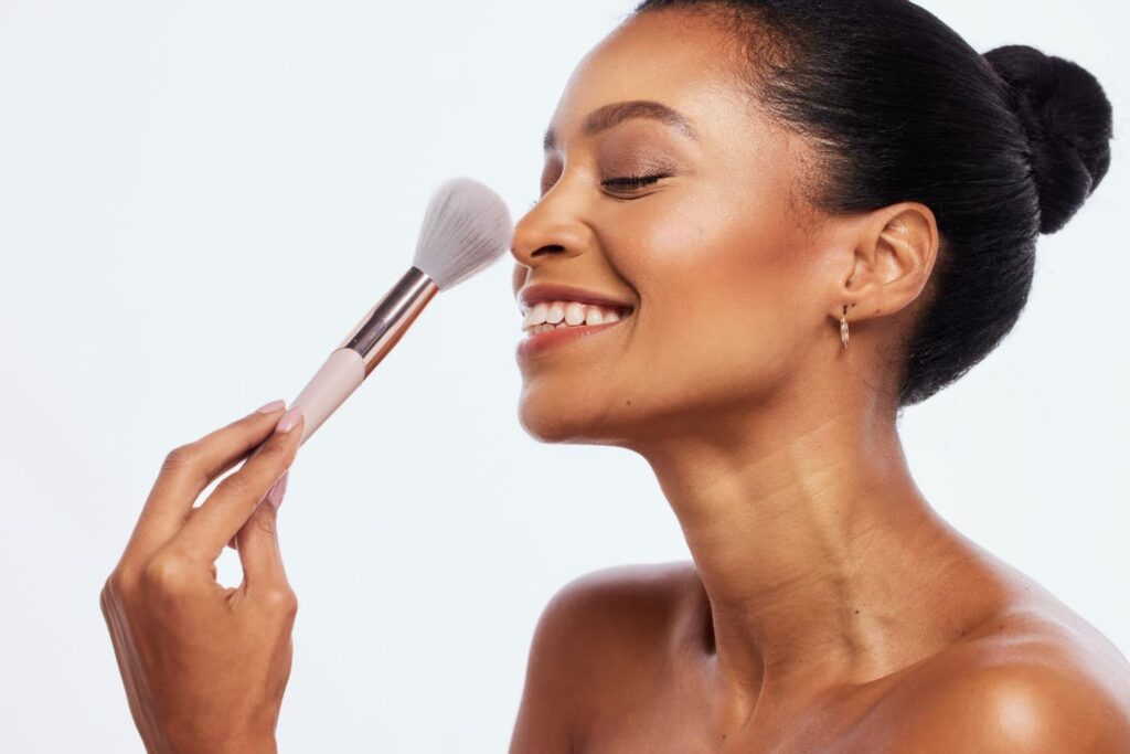 A woman applying the best translucent powders for a flawless finish