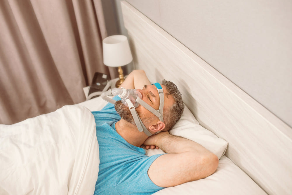 A sleeping man using the best CPAP mask for beards
