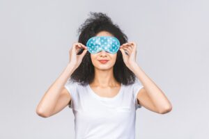 A woman with a sleeping mask as a warm compress