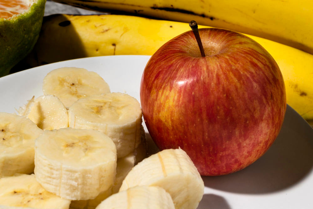 Banana slices and an apple