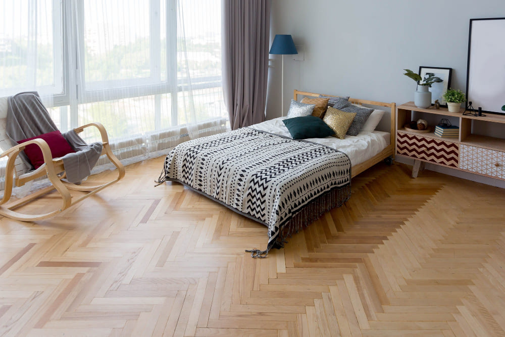 A bedroom with ample floor space in an apartment