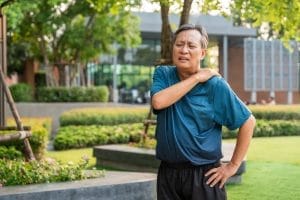 Senior asian old man with sportswear has an inflamed neck and shoulder pain. Old man senior has problem with structural posture