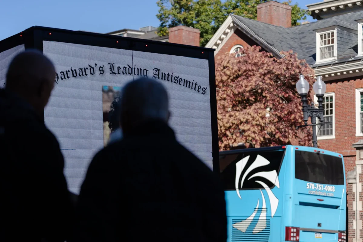 A billboard truck displayed the names and faces of Harvard students who were linked to an anti-Israel letter. Credit...Sophie Park for The New York Times
