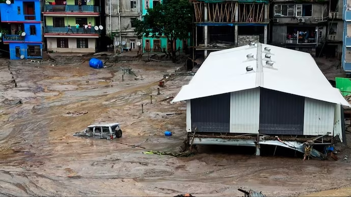 Heavy rains caused a glacial lake in Sikkim to burst, resulting in 14 deaths and 102 missing