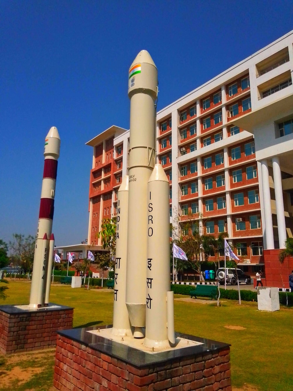 a large rocket sitting on top of a brick block