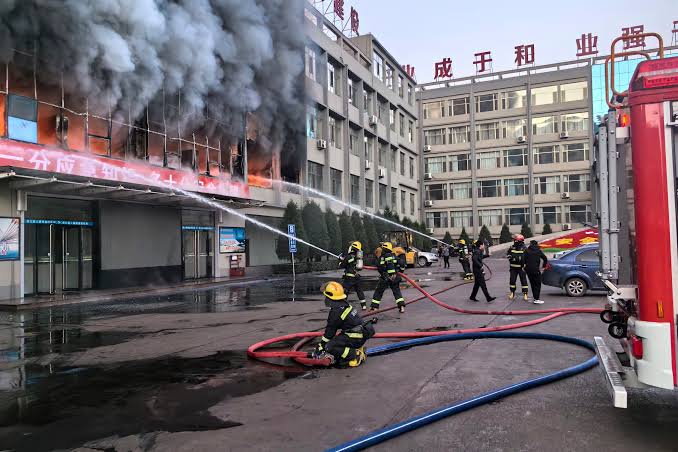 Photograph by The Independent | Fire at China's Coal Mining Company Building