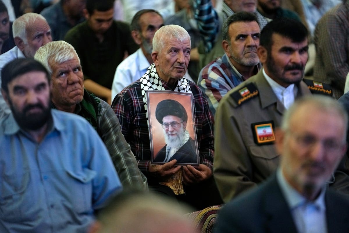 A worshiper holds a poster of Supreme Leader Ali Khamenei at Friday prayers at the Imam Khomeini Grand Mosque in Tehran on Friday, a week before the presidential election. (Vahid Salemi/AP)