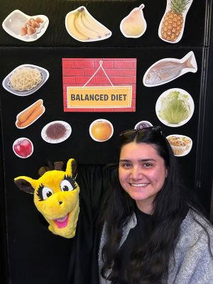 Masters student Cheyenne Koro with Harold the giraffe in Life Education Trust classroom