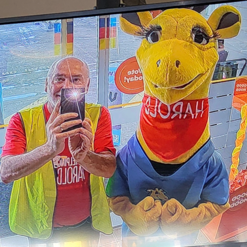 John Davies with Harold the giraffe mascot