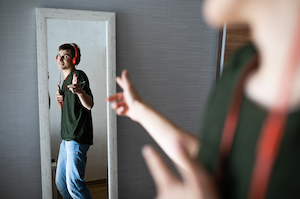Teenager dancing in front of mirror