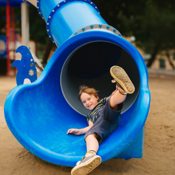 Boy emerges from playground slide