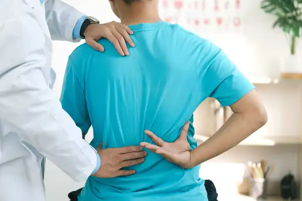 Doctor physiotherapists treat lower back pain in patients in the hospital. back injuries and back massages for muscle recovery.The concept of treating illnesses with physical therapy.