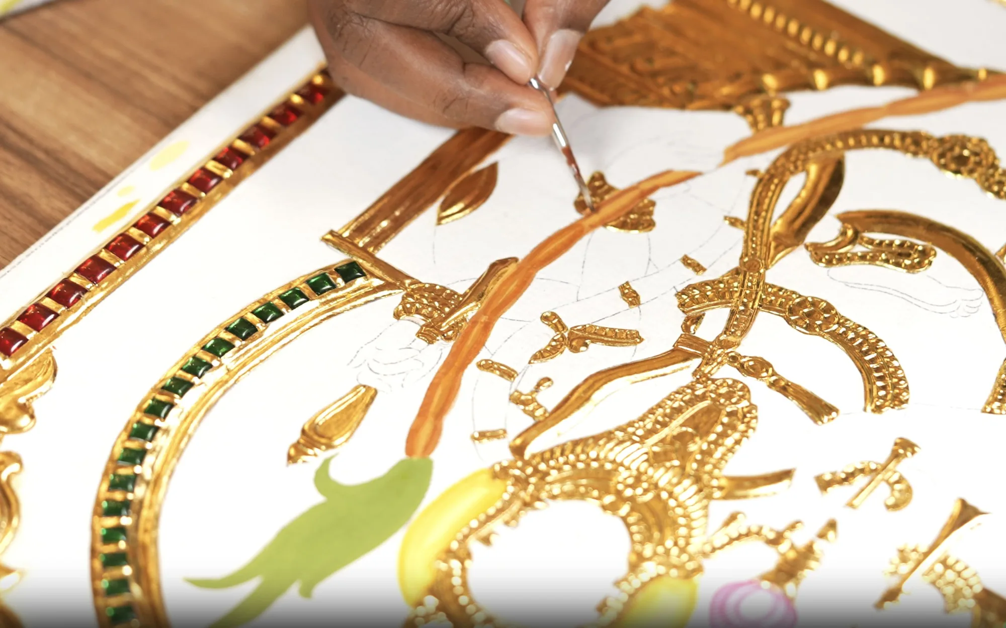 Detailing a Tanjore painting with gold