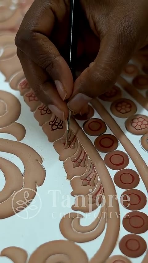 Raised gesso relief being built up by hand on a Tanjore board