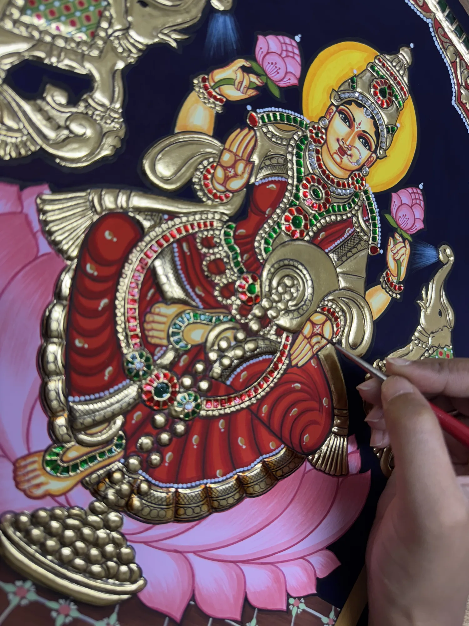 The lotus being painted in a Tanjore work in progress