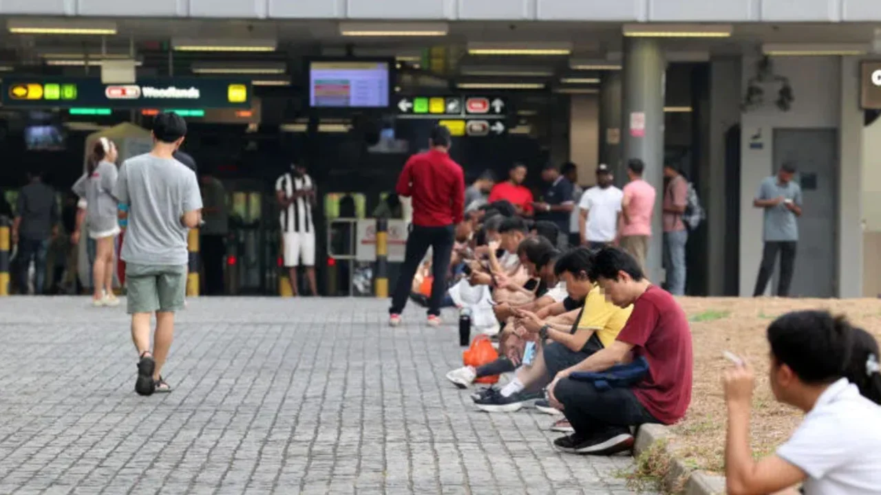 Smokers gather near Woodlands MRT station, leaving cigarette butts for others to deal with