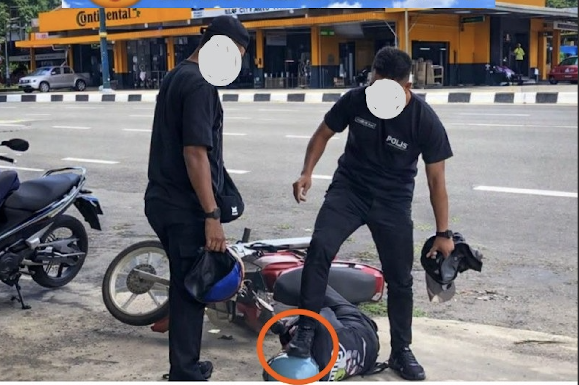 Police stepping on motorcyclist head sparks online anger in Malaysia