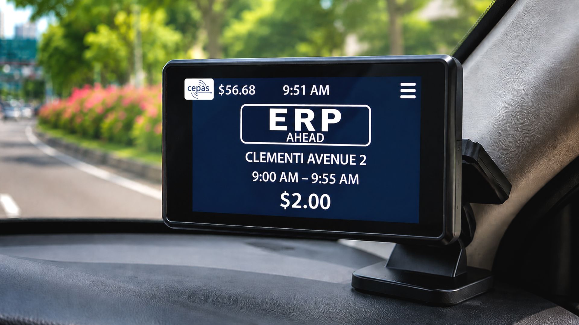 A CEPAS-enabled ERP 2.0 onboard unit mounted inside a car, displaying an “ERP Ahead” road pricing alert for Clementi Avenue 2; the digital screen is in focus while the road and greenery outside the windshield are in the background