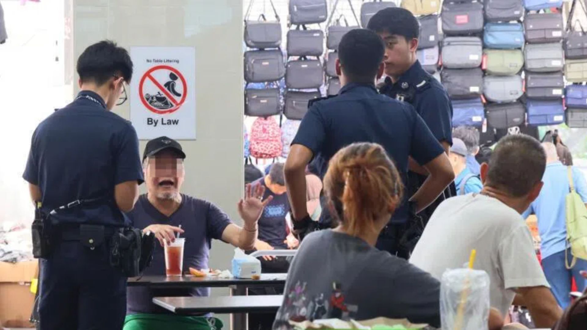 Man and woman shared a table at a hawker centre and threw ho