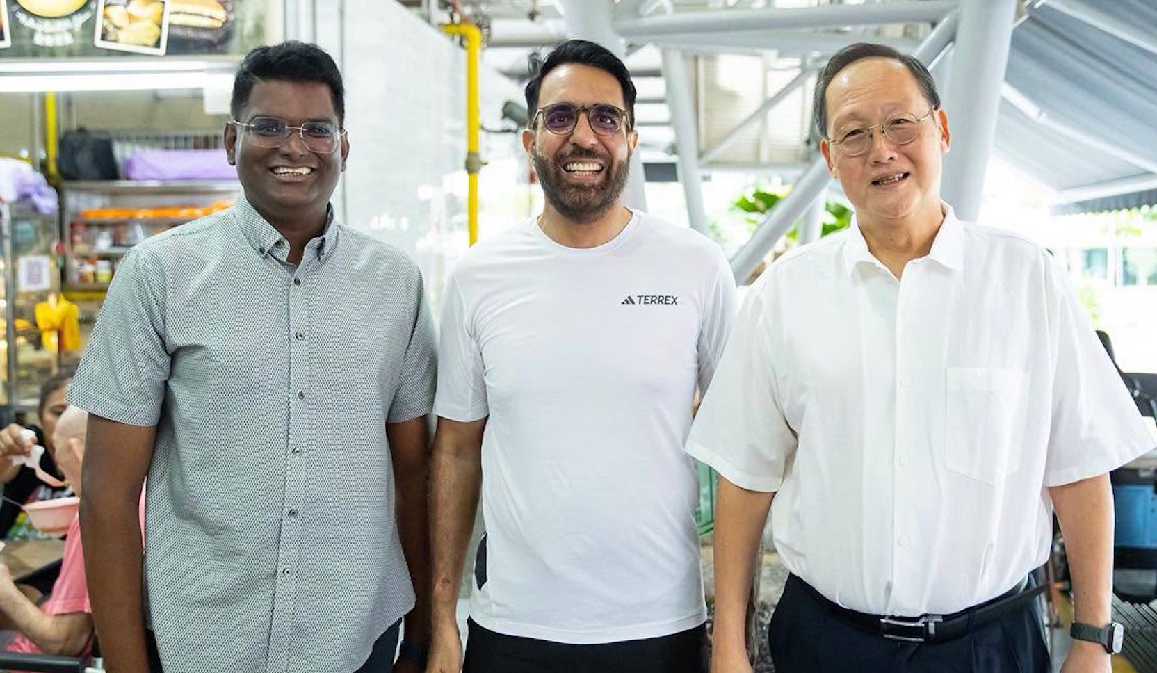 Pritam Singh greets Tan See Leng, grassroots adviser, at Eunos hawker centre during ministerial visit