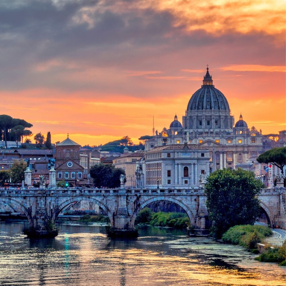 St Peter's Basilica at sunset across the Tiber in Rome