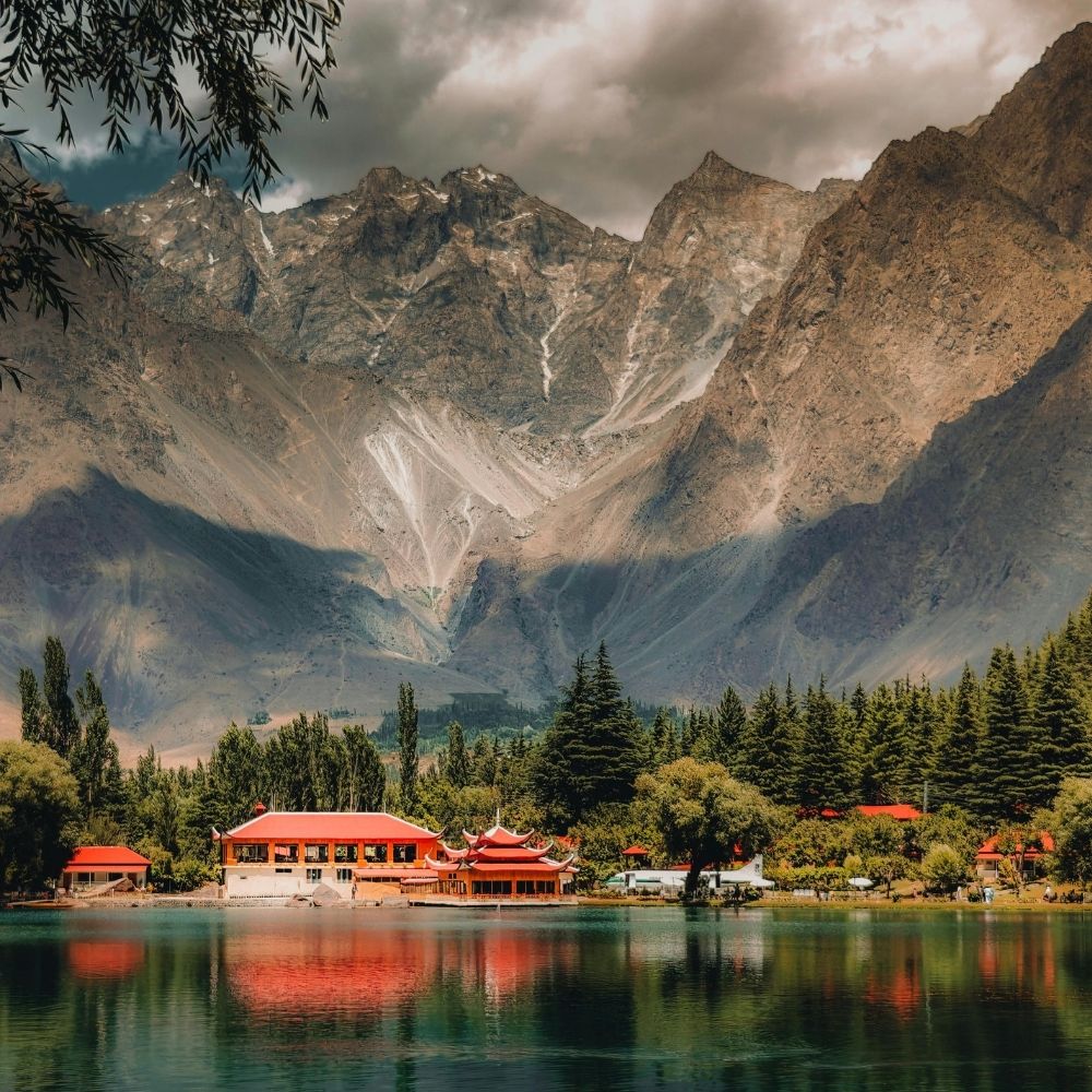 A lakeside pavilion beneath rugged mountains