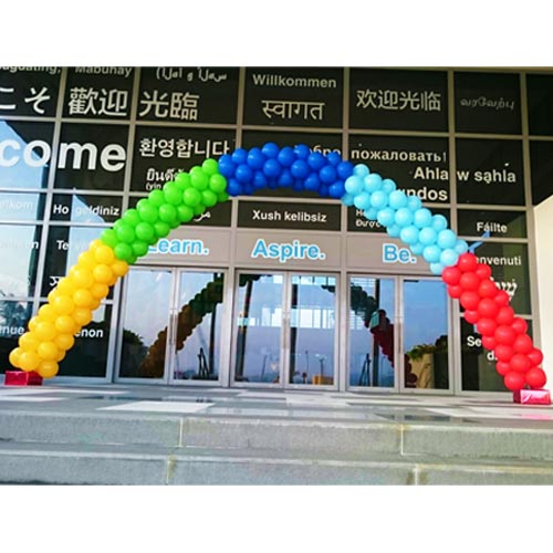 Giant rainbow balloon arch for school entrance