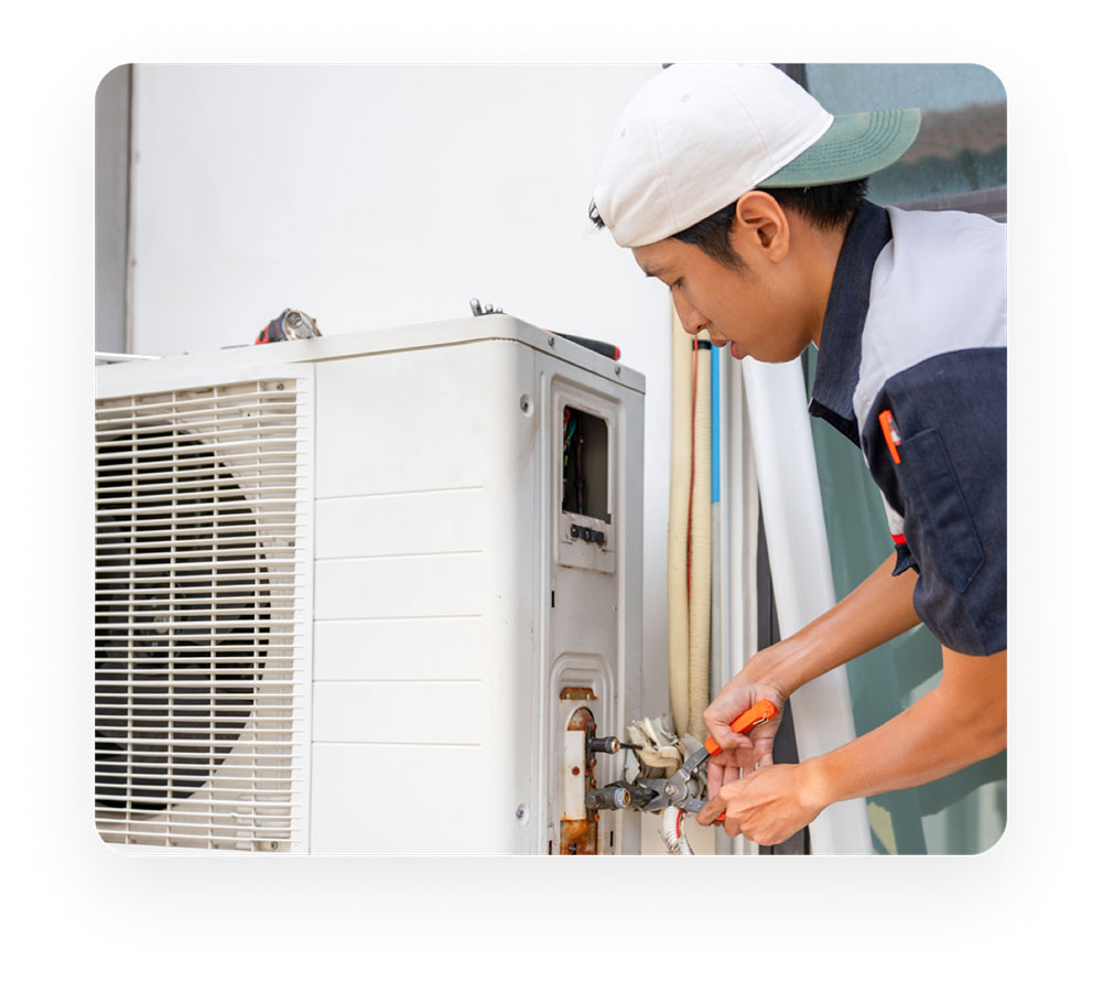 Omega Cool technician servicing an outdoor aircon unit