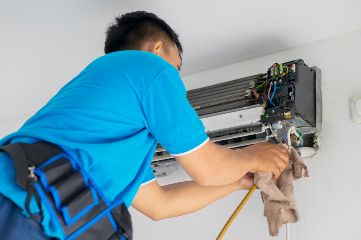Technician repairing internal aircon components