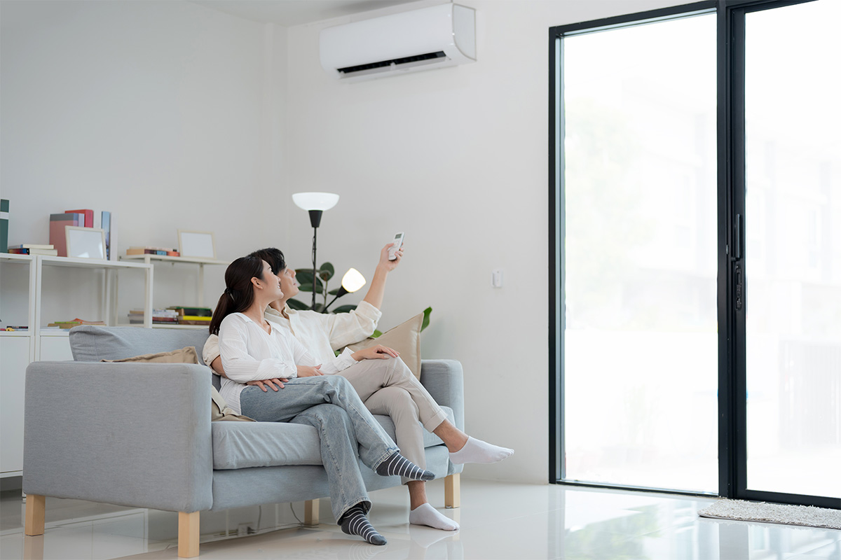 Family using a remote to control aircon in an HDB home