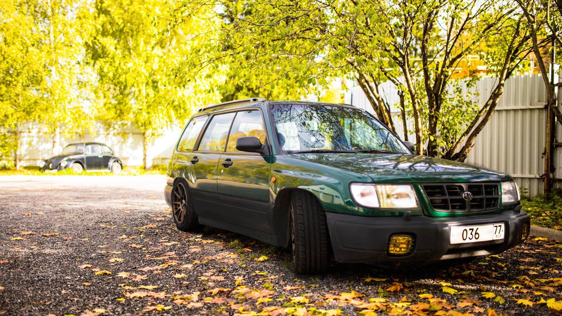 Front view of a 1999 Subaru Forester parked in a scenic area.