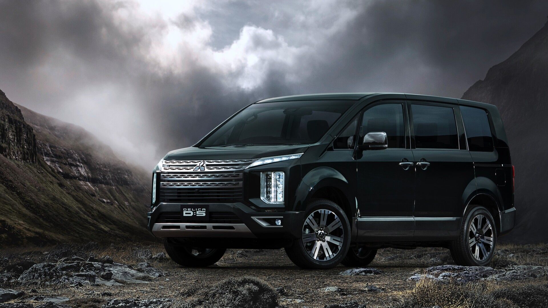 Side view of a Mitsubishi Delica in a mountain region