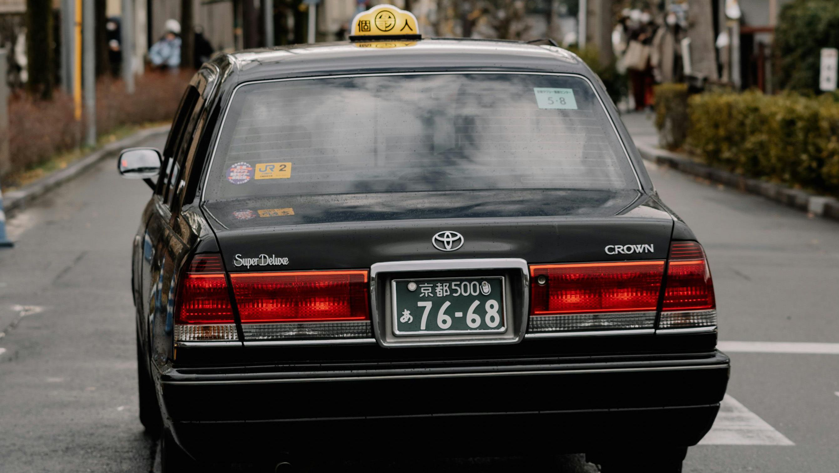 Toyota crown, taxi, driving down a lane